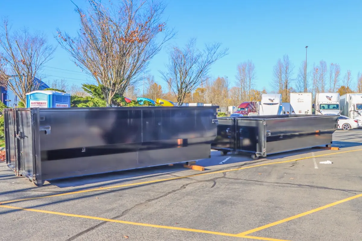 Professional dumpster rental service with roll-off container on residential driveway in South Monrovia Island